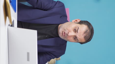 Vertical-video-of-Businessman-working-on-laptop-unhappy-and-negative.